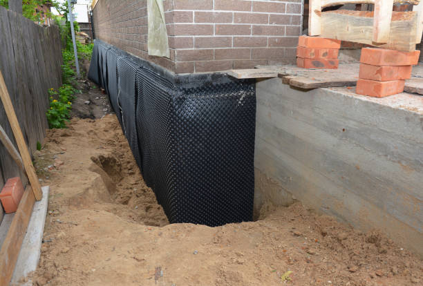 SJ Waterproofing Pros technician performing targeted Basement Waterproofing assessment in Lansing, KS